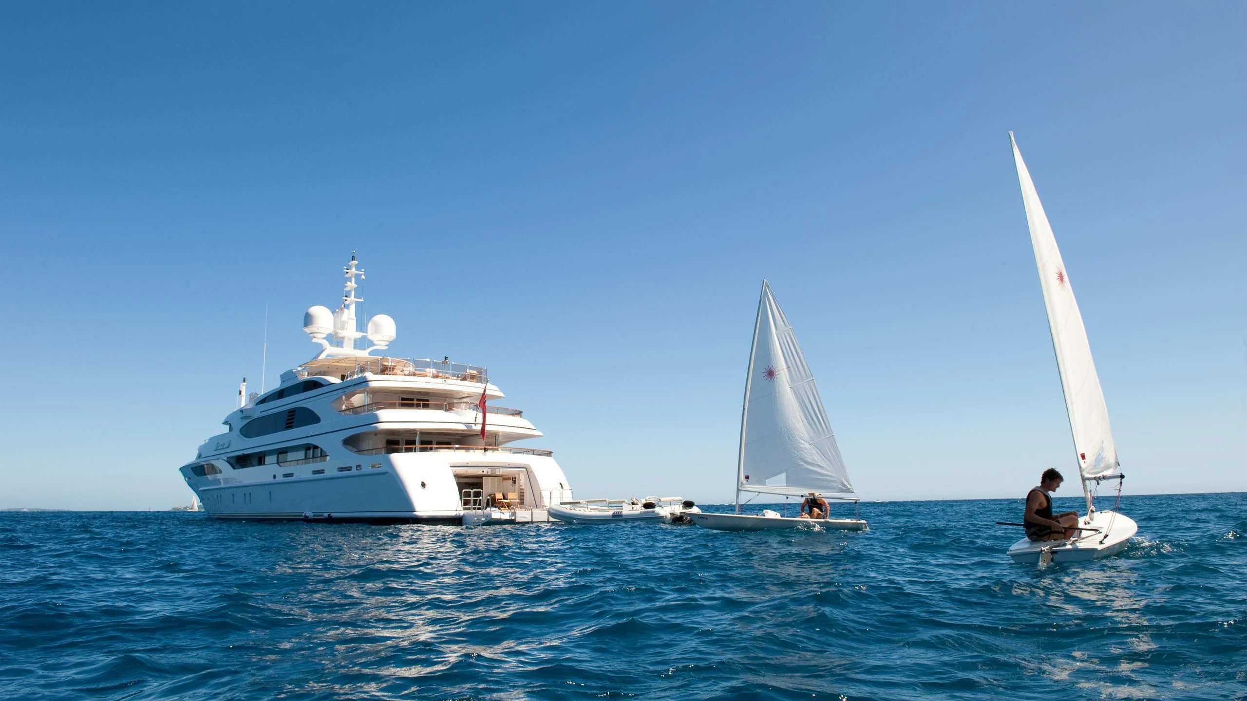 a couple of people sailing on the ocean aboard DILARA Yacht for Sale