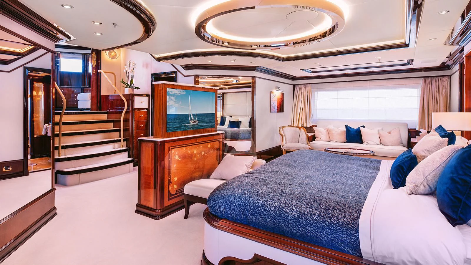 a bedroom with a bed and a tv aboard DILARA Yacht for Sale