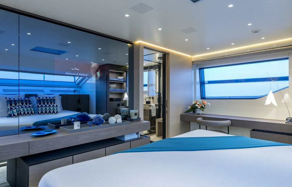 a room with a bed and a desk aboard DILARA Yacht for Sale