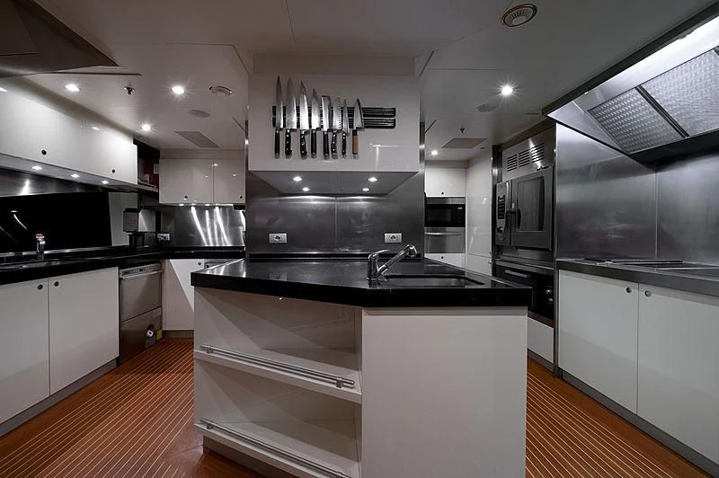 a kitchen with white cabinets aboard DILARA Yacht for Sale