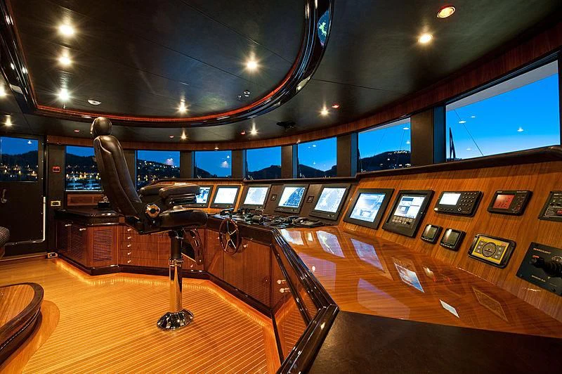 a room with a large desk and chairs with screens aboard DILARA Yacht for Sale