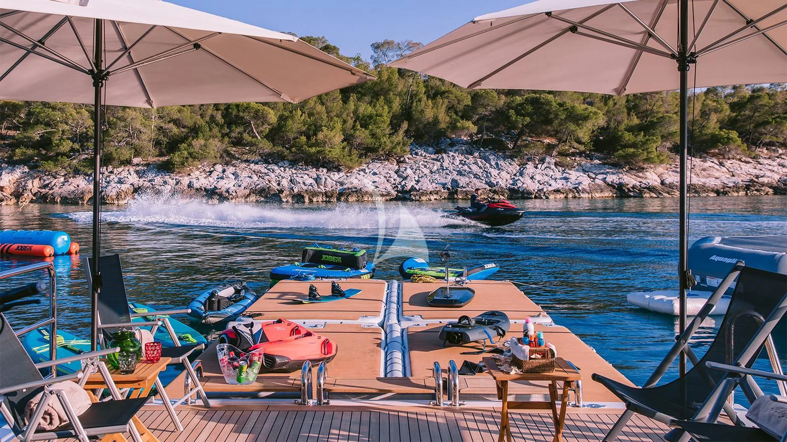a beach with boats and umbrellas aboard DILARA Yacht for Sale