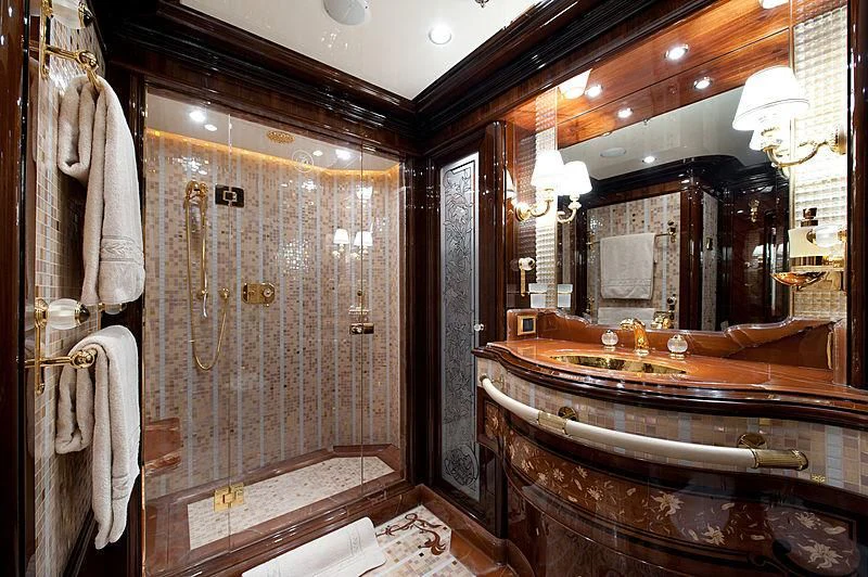 a large bathroom with a large mirror aboard DILARA Yacht for Sale
