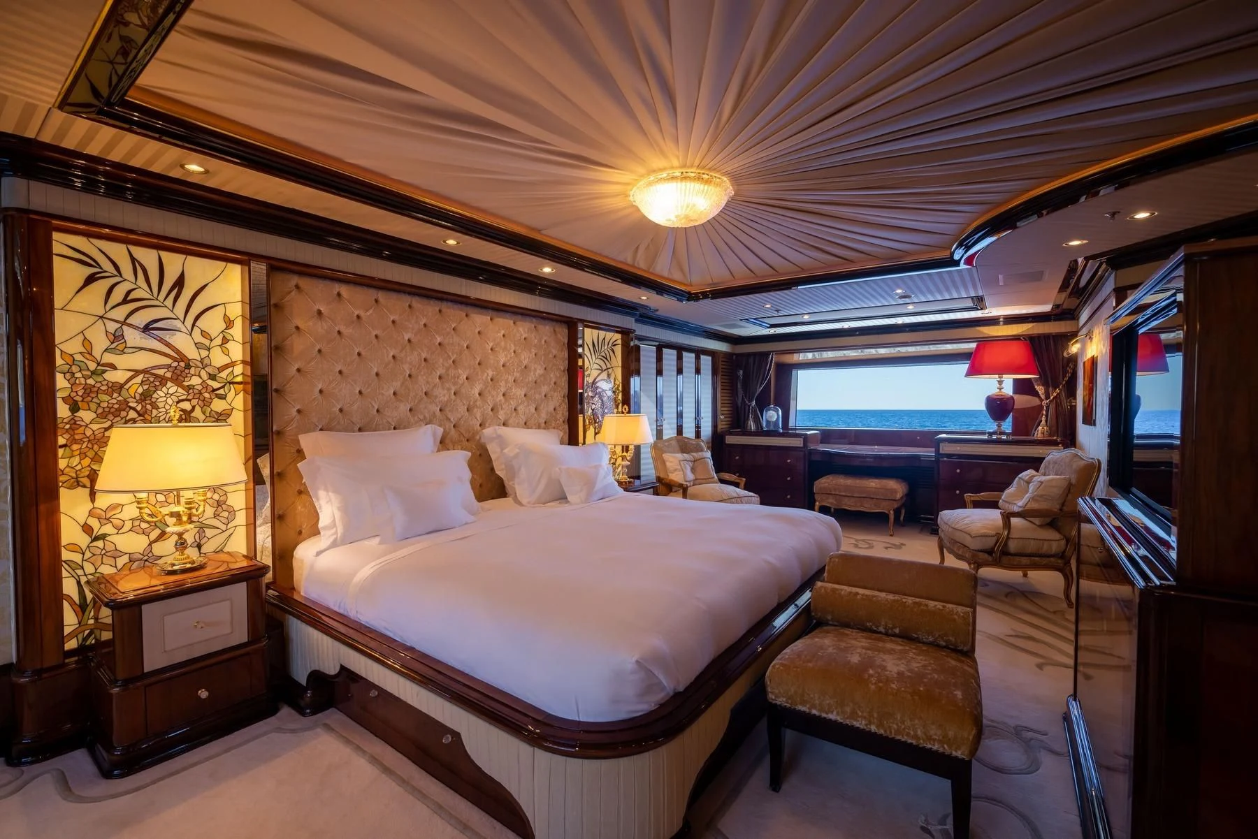 a hotel room with a bed and a chair aboard DILARA Yacht for Sale