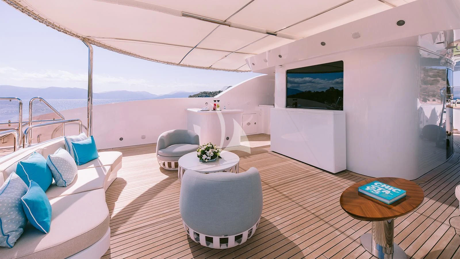 a room with a table and chairs aboard DILARA Yacht for Sale