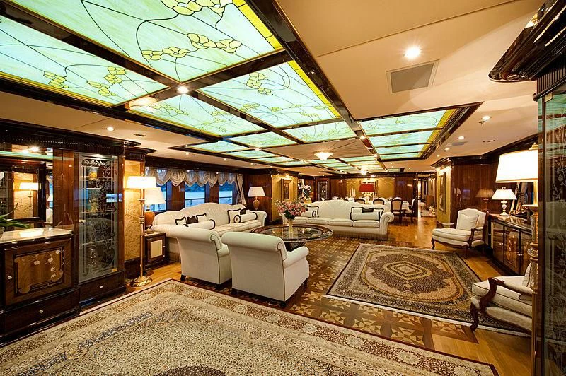 a large living room with a large chandelier aboard DILARA Yacht for Sale