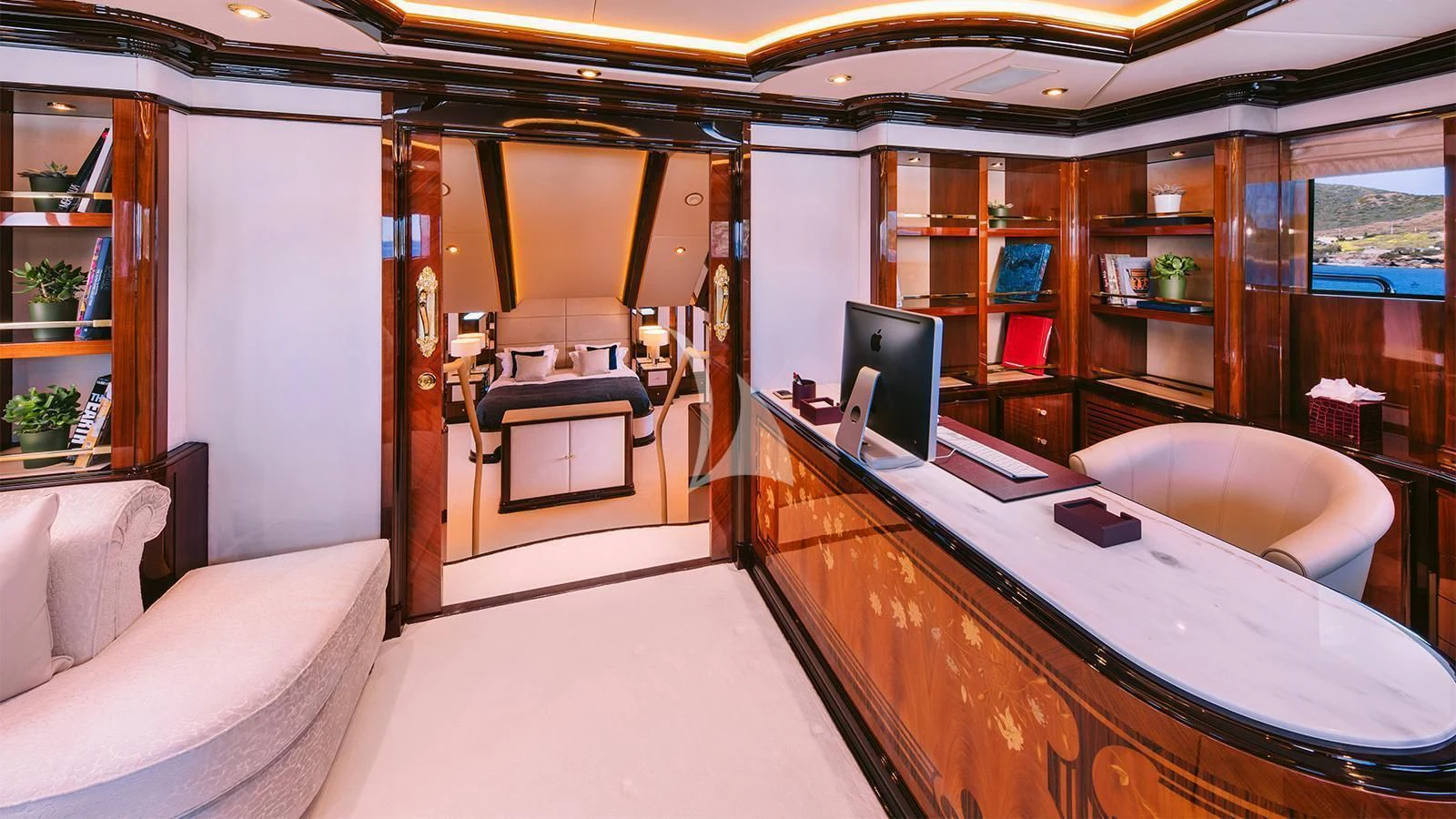 a room with a desk and a bed aboard DILARA Yacht for Sale