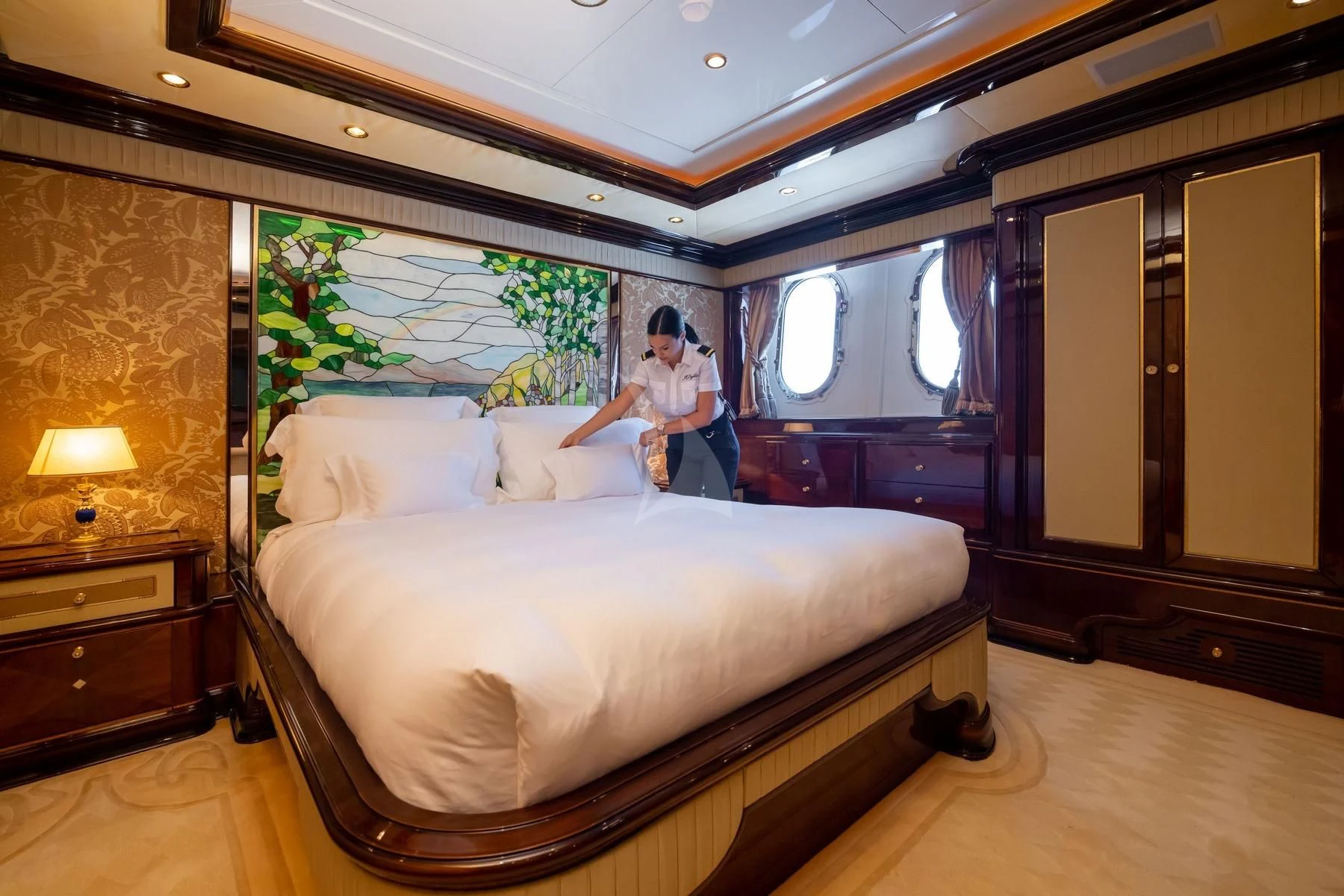 a person sitting on a bed aboard DILARA Yacht for Sale