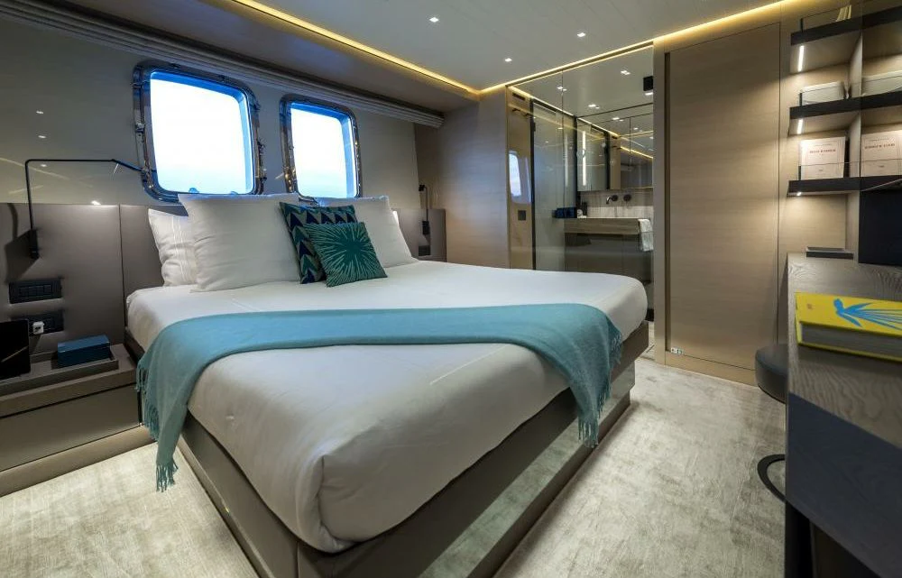 a room with a bed and a window aboard DILARA Yacht for Sale