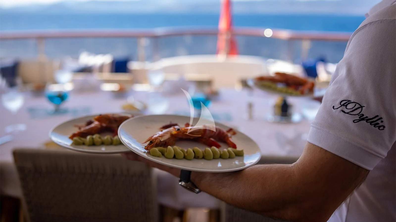a person holding a plate of food aboard DILARA Yacht for Sale