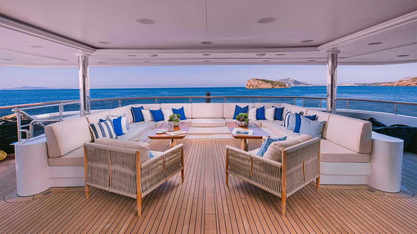 a room with a table chairs and a large body of water aboard DILARA Yacht for Sale