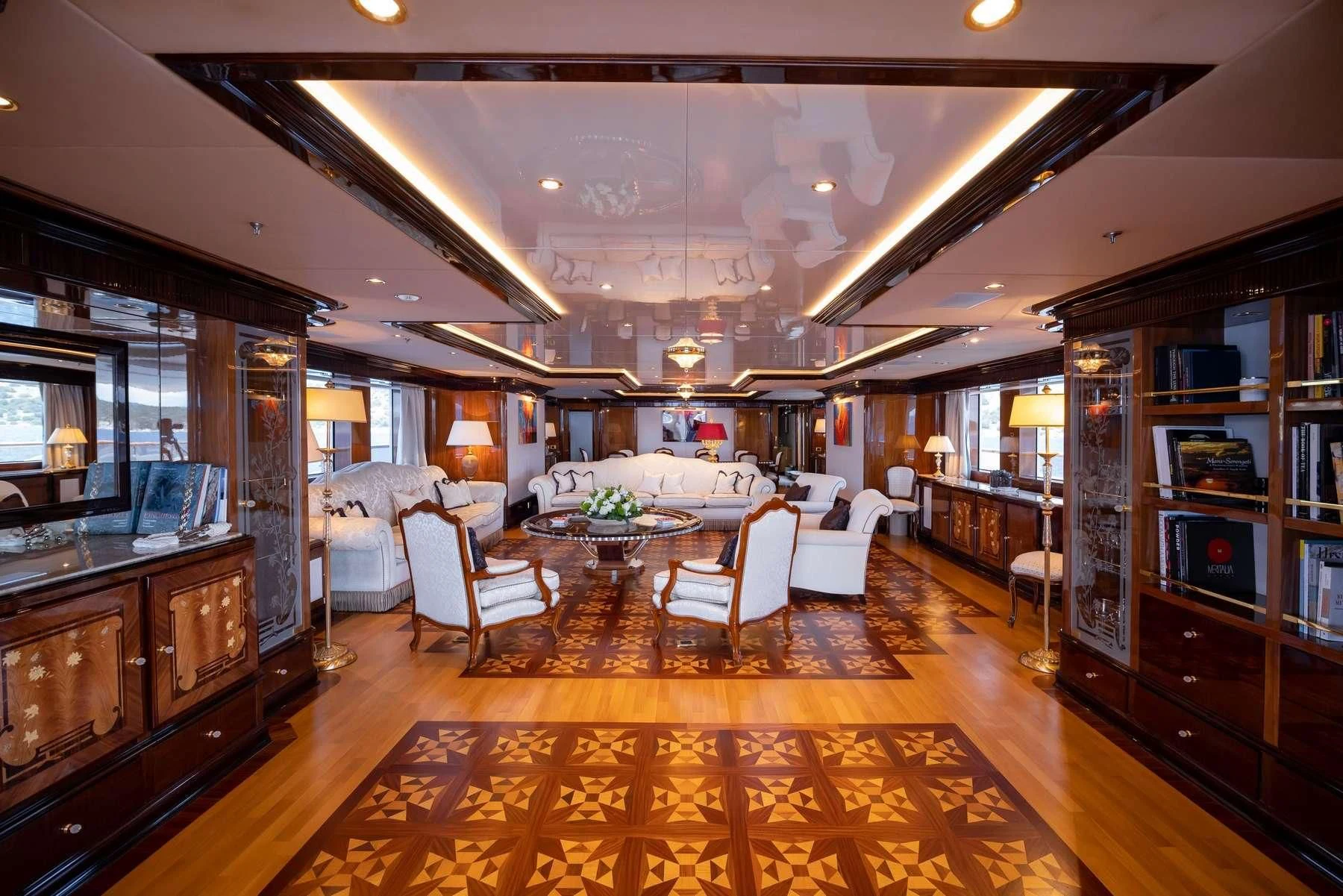 a large room with a table and chairs aboard DILARA Yacht for Sale