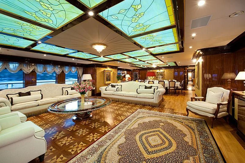 a large living room with a large chandelier aboard DILARA Yacht for Sale