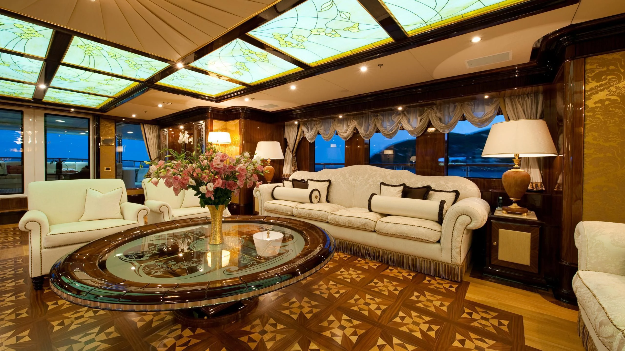 a living room with a large chandelier aboard DILARA Yacht for Sale