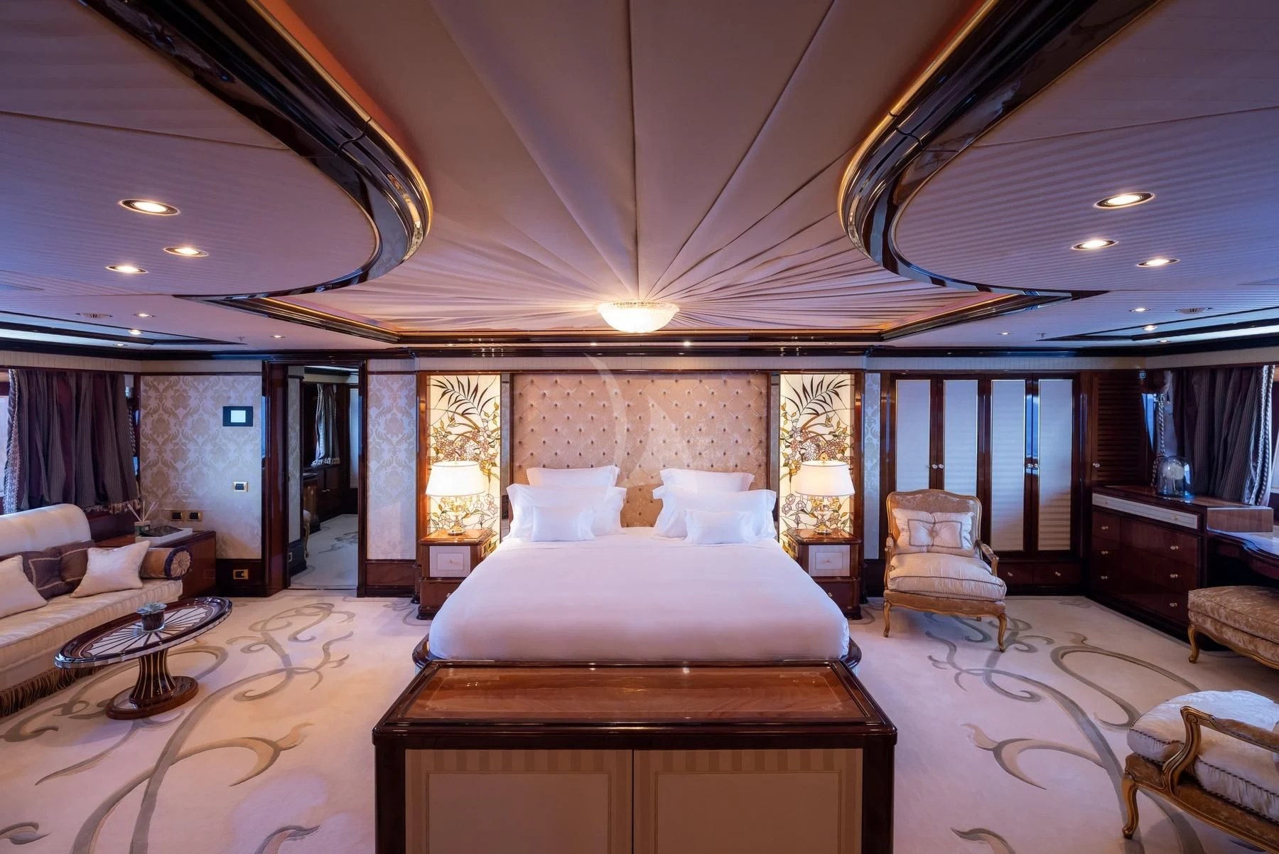 a large bedroom with a large bed aboard DILARA Yacht for Sale