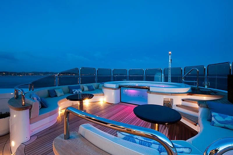 a pool with a deck and chairs aboard DILARA Yacht for Sale