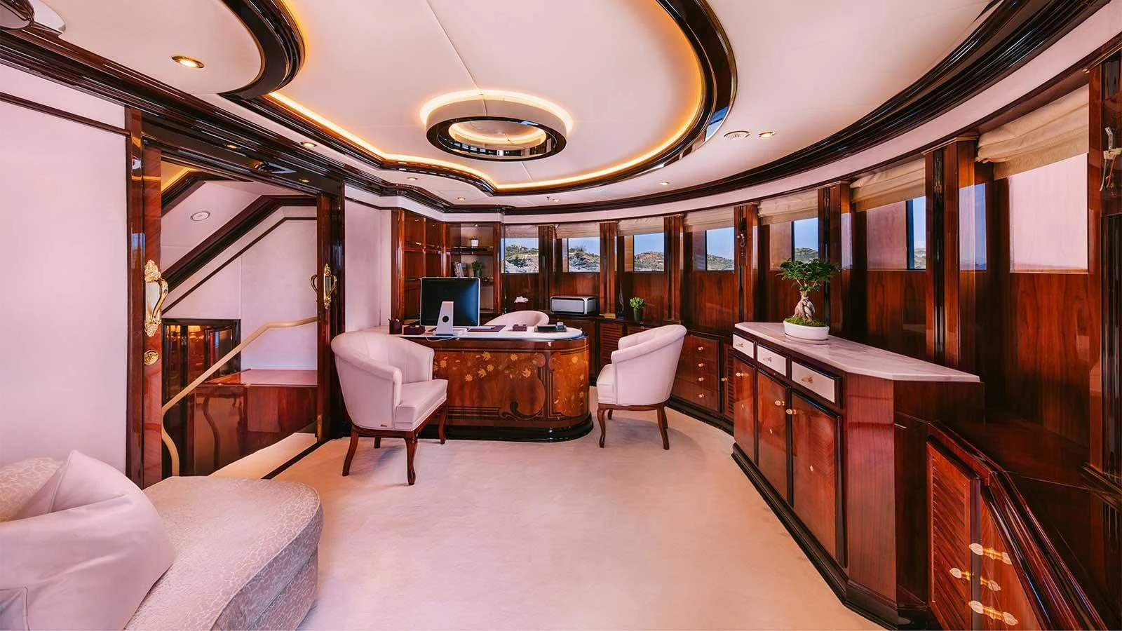 a room with a desk and chairs aboard DILARA Yacht for Sale
