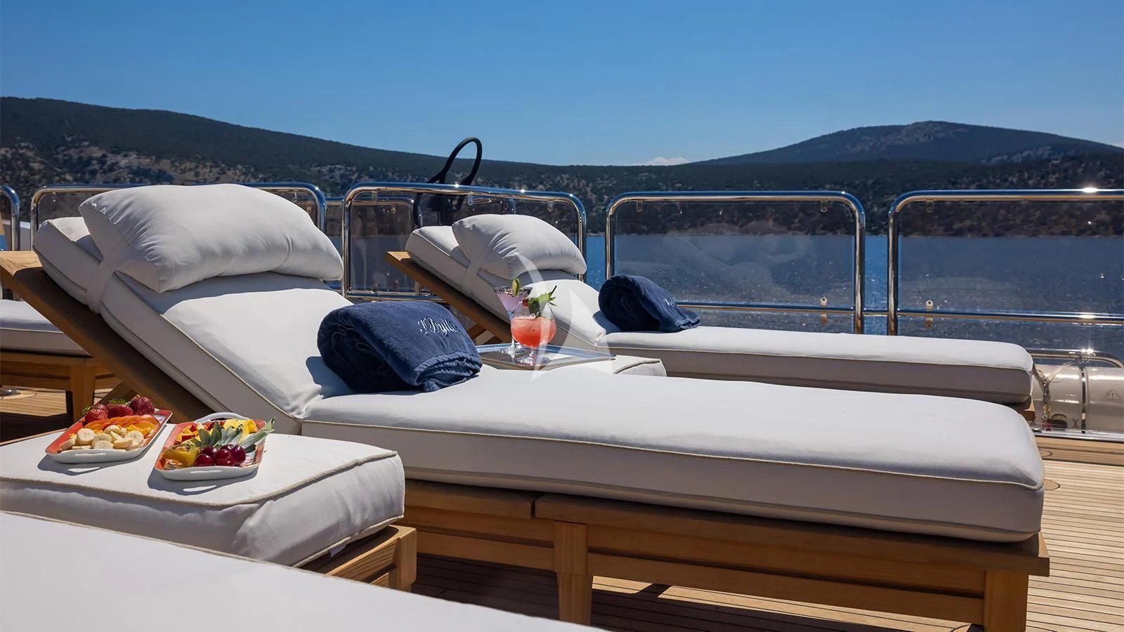 a bed with a tray of food on it aboard DILARA Yacht for Sale