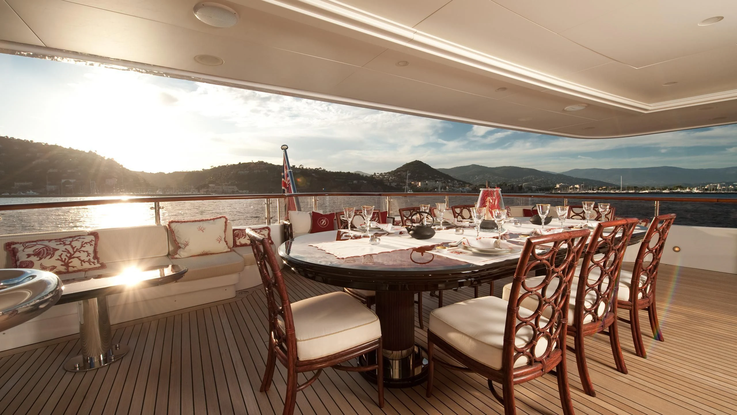 a table set for a dinner on a deck aboard DILARA Yacht for Sale
