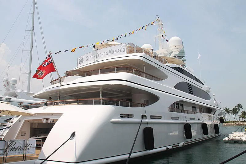 a large white yacht with a red flag on the front aboard DILARA Yacht for Sale