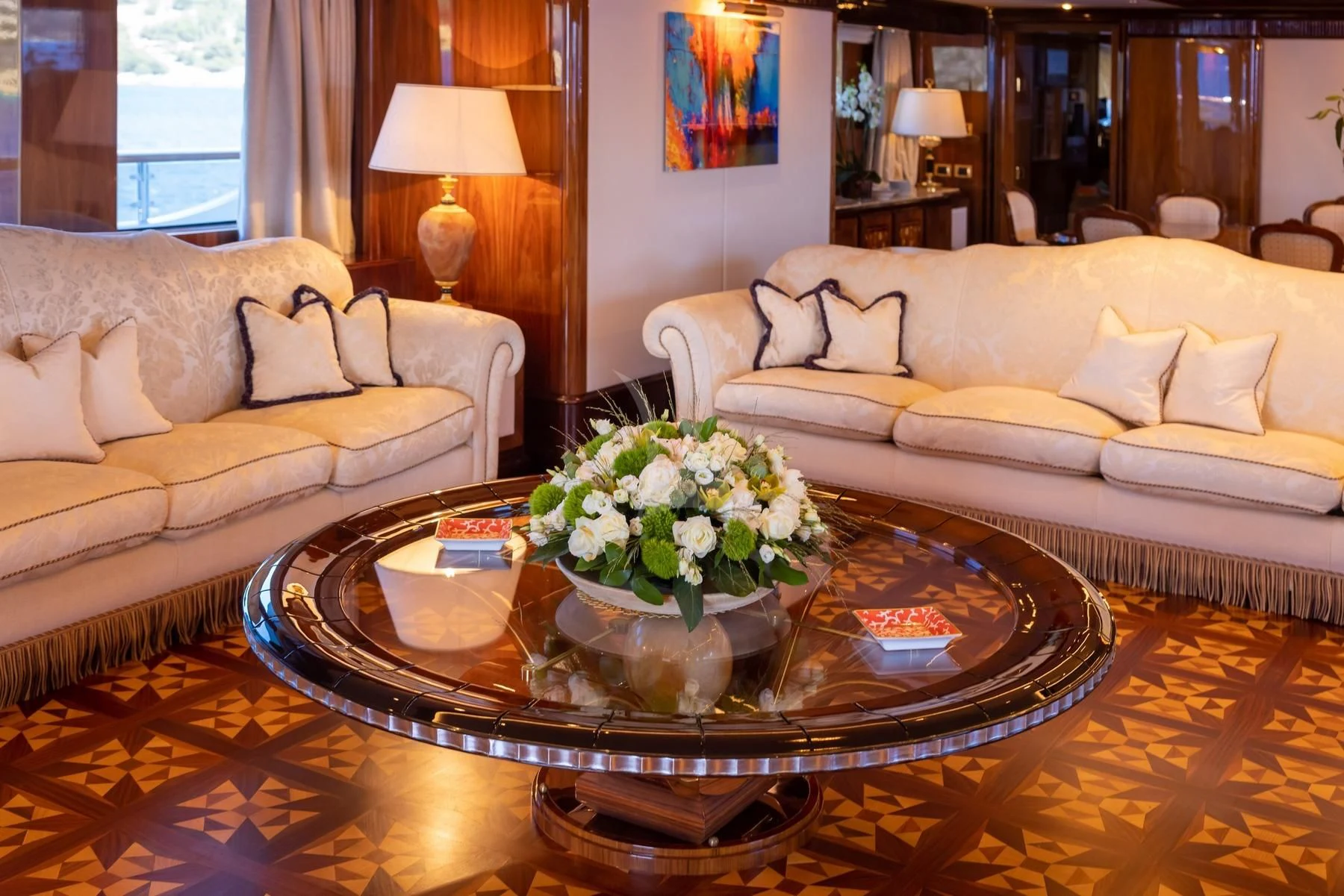 a living room with a table and couches aboard DILARA Yacht for Sale