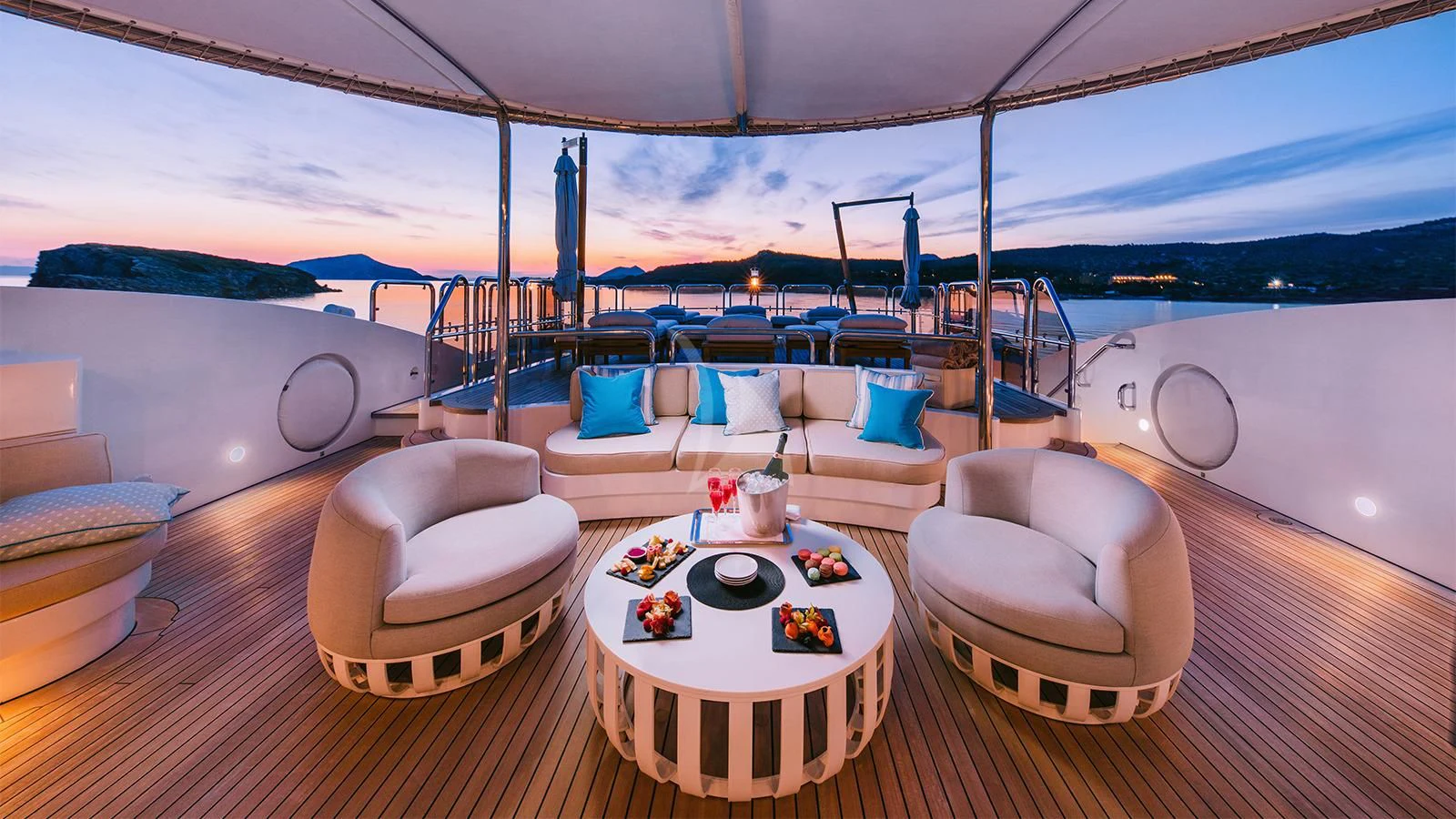 a room with a table chairs and a view of the ocean aboard DILARA Yacht for Sale