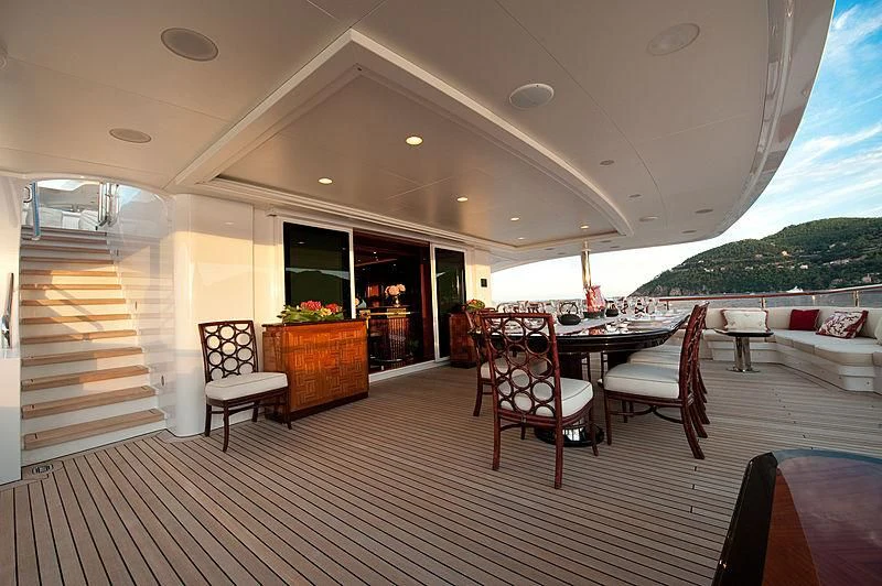 a room with a table chairs and a large window aboard DILARA Yacht for Sale