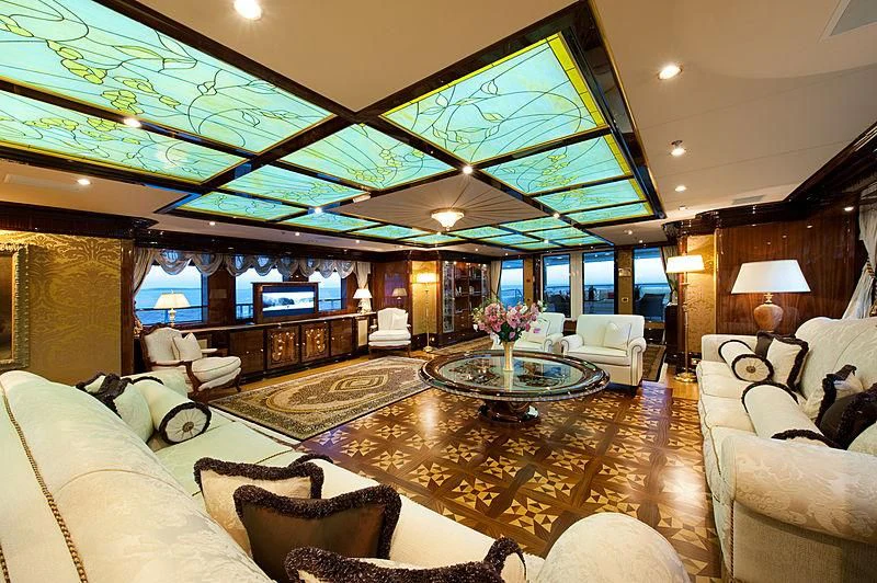 a living room with a large chandelier aboard DILARA Yacht for Sale
