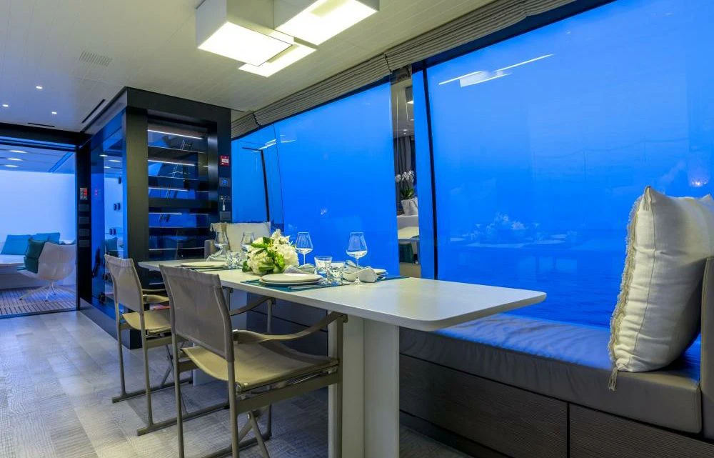 a room with a table and chairs aboard DILARA Yacht for Sale