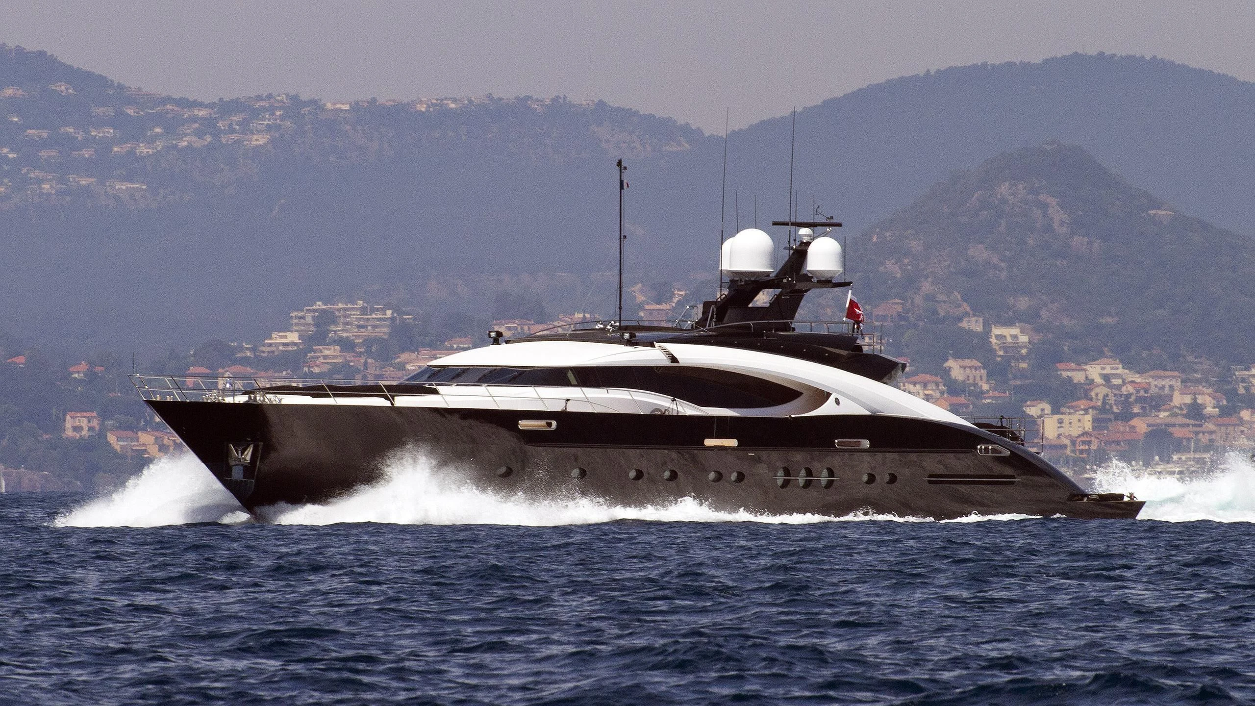 a large ship on the water aboard DOMINO Yacht for Sale