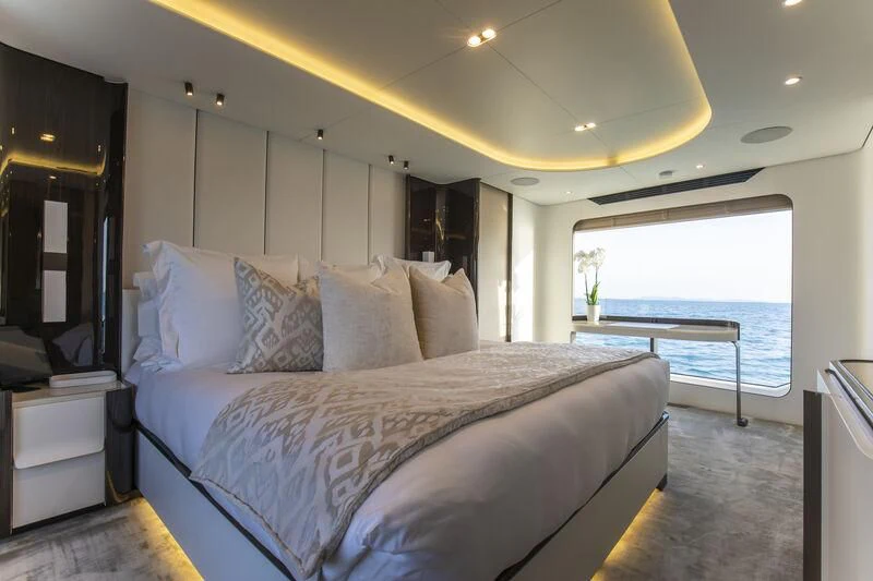 a bed with white sheets aboard NEMESIS Yacht for Sale