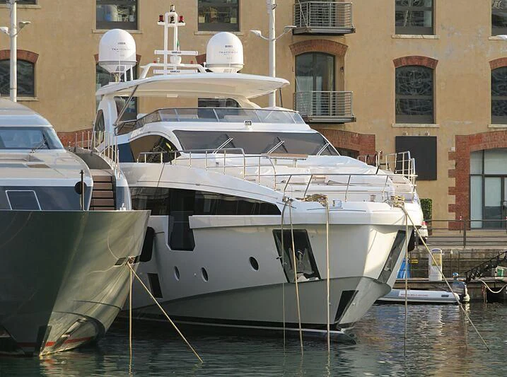 a couple of boats sit in a harbor aboard NEMESIS Yacht for Sale
