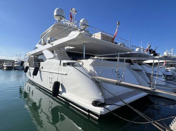 a large white boat in a harbor aboard NEMESIS Yacht for Sale