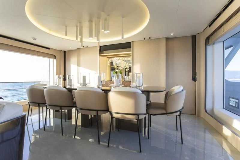 a room with a table and chairs aboard NEMESIS Yacht for Sale