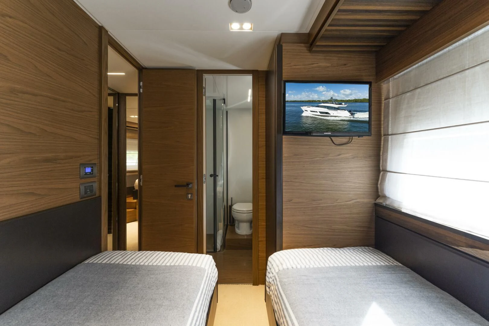 a room with a bed and a television aboard LEGEND Yacht for Sale