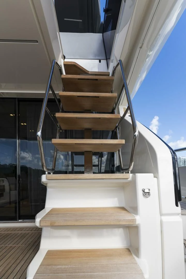 a staircase with a wood railing aboard LEGEND Yacht for Sale