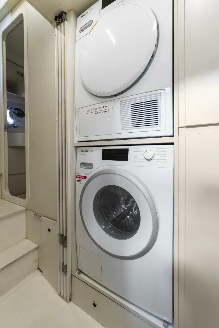 a washing machine in a room aboard LEGEND Yacht for Sale