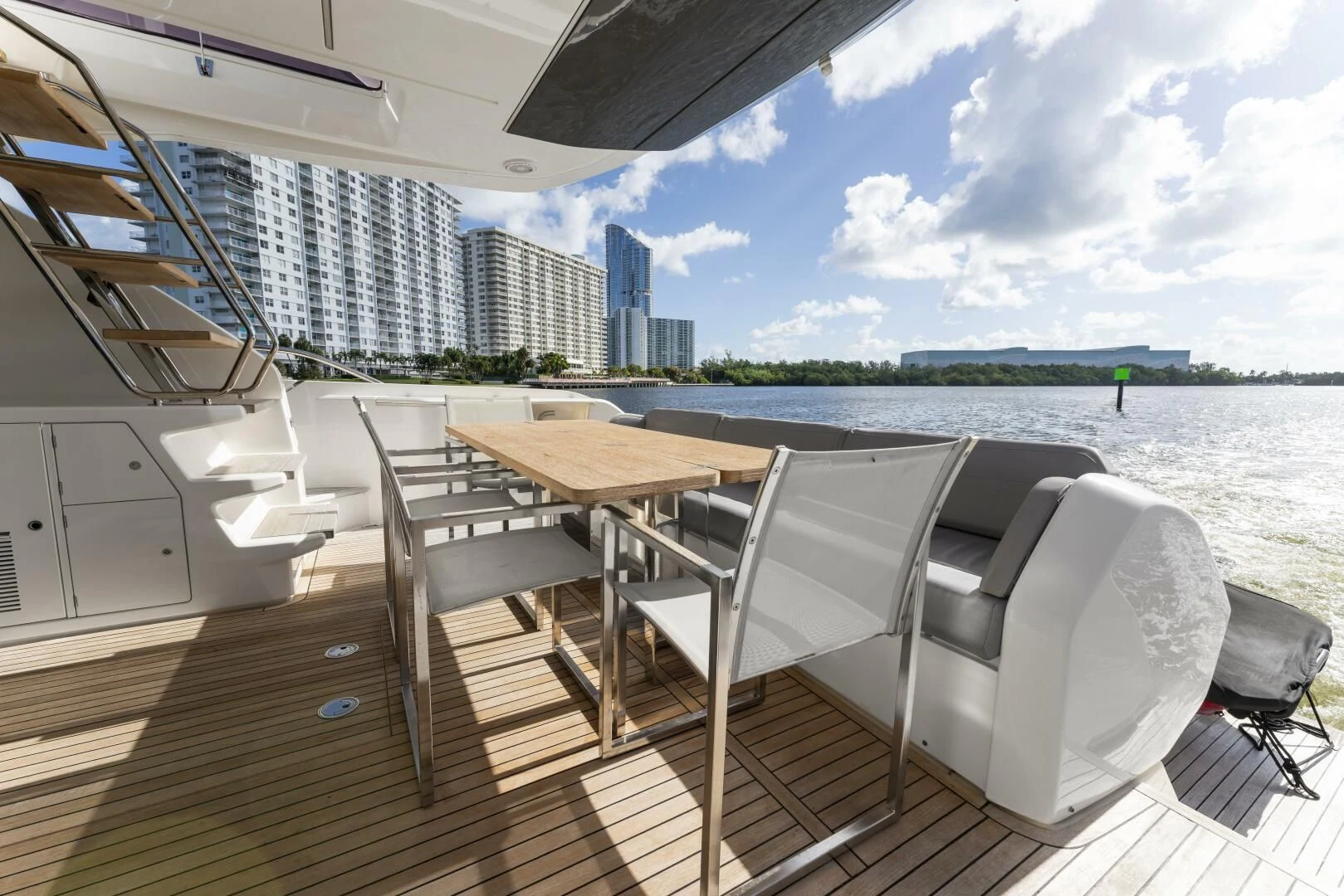 a deck with a table and chairs on it aboard LEGEND Yacht for Sale