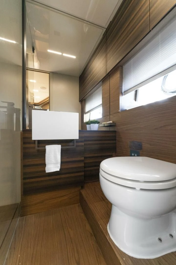 a bathroom with a wood floor aboard LEGEND Yacht for Sale