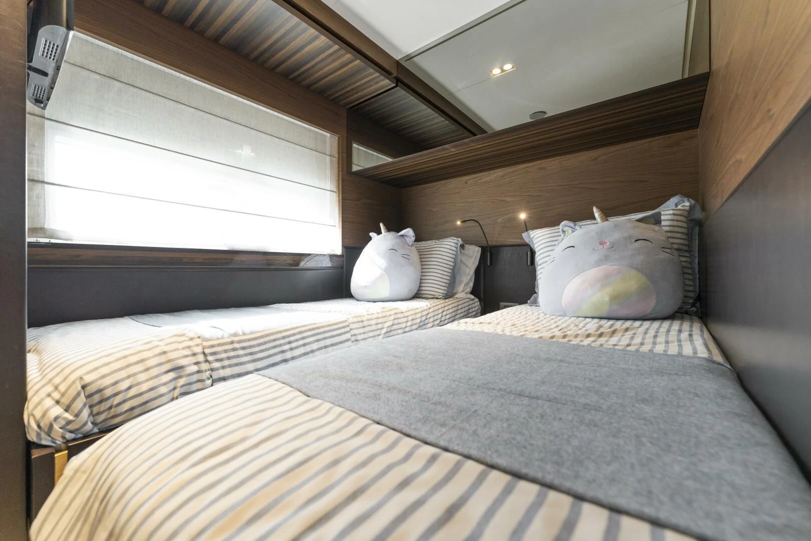 a bed with a white pillow aboard LEGEND Yacht for Sale