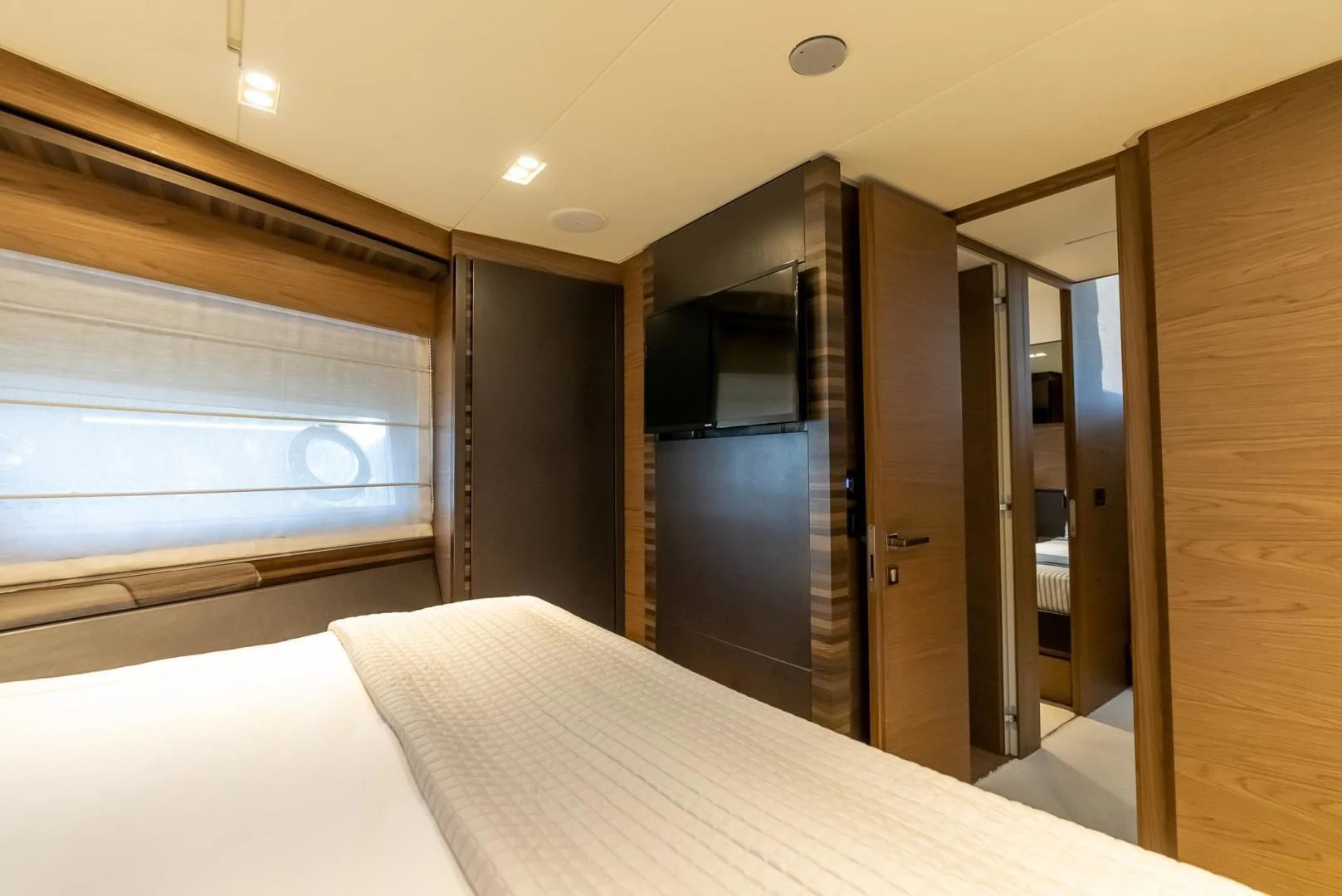 a room with a bed and a closet aboard LEGEND Yacht for Sale