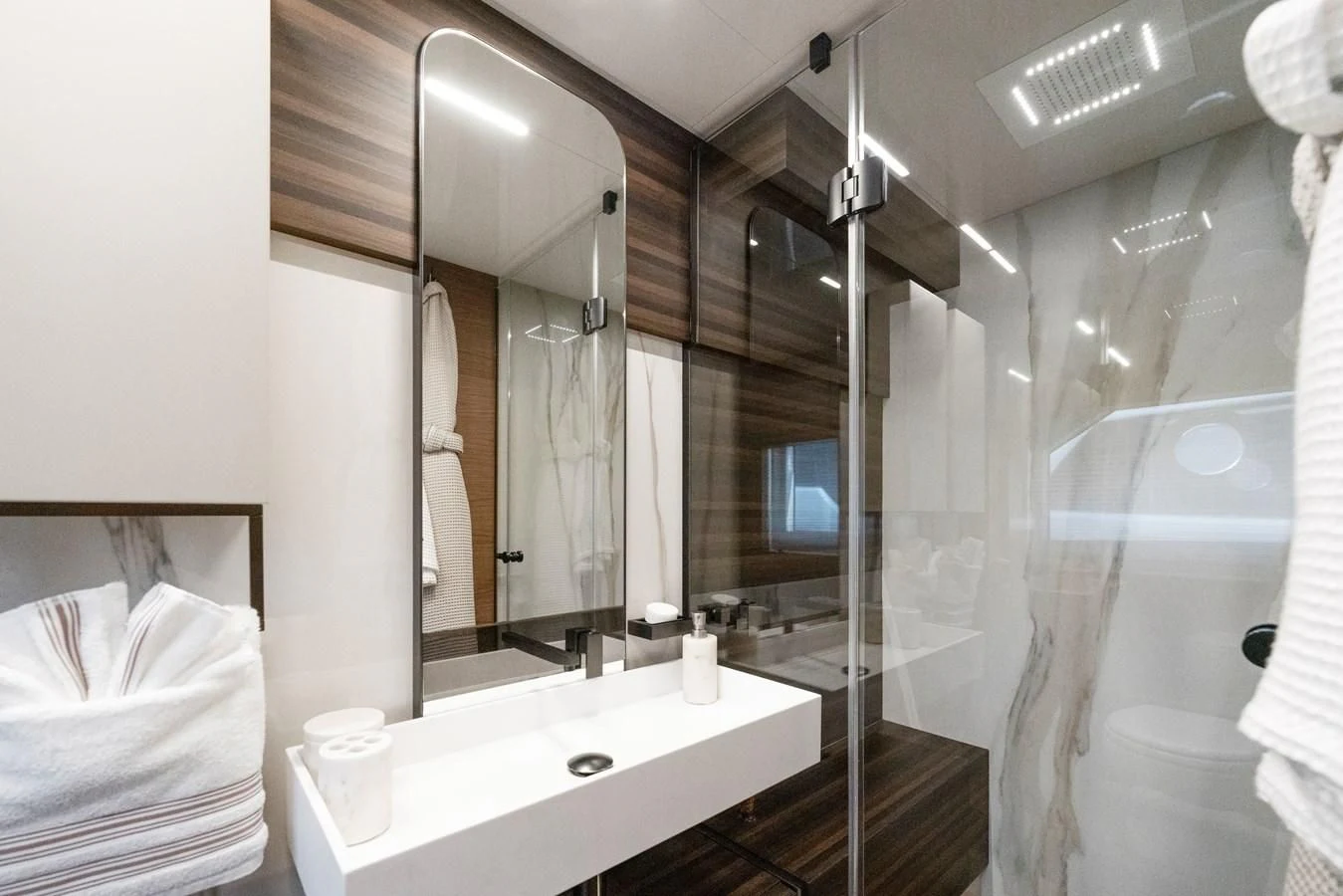a bathroom with a large mirror aboard LEGEND Yacht for Sale