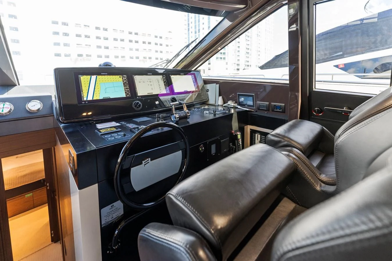 inside of a vehicle with a screen and a seat with a computer on it aboard LEGEND Yacht for Sale