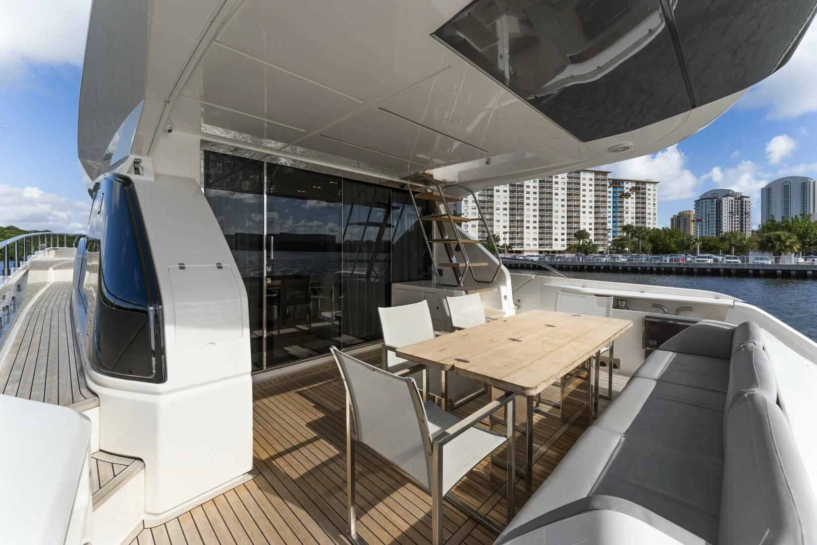 a deck with a table and chairs on it aboard LEGEND Yacht for Sale