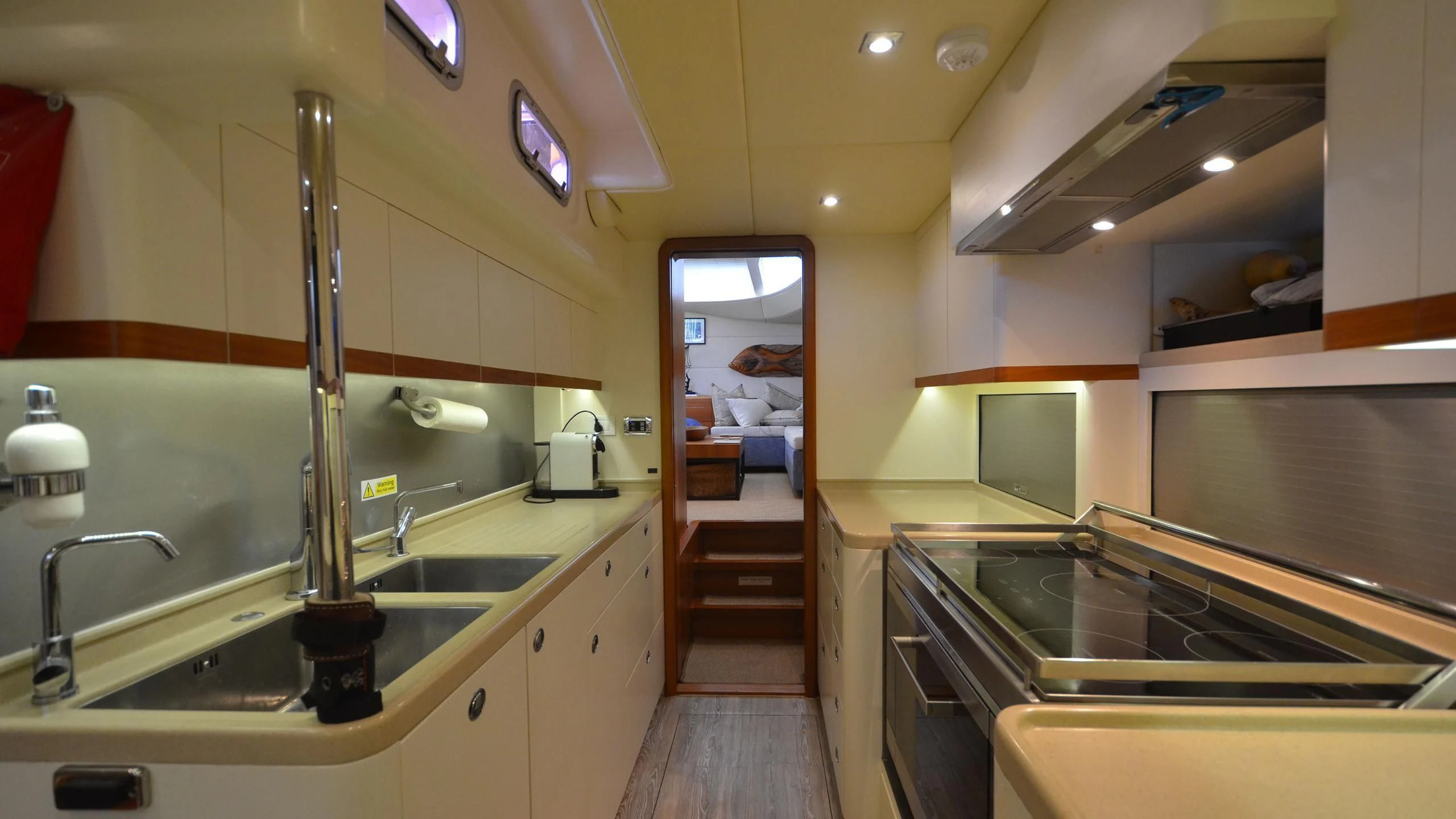 a kitchen with a sink and a microwave aboard DANNESKJOLD Yacht for Sale