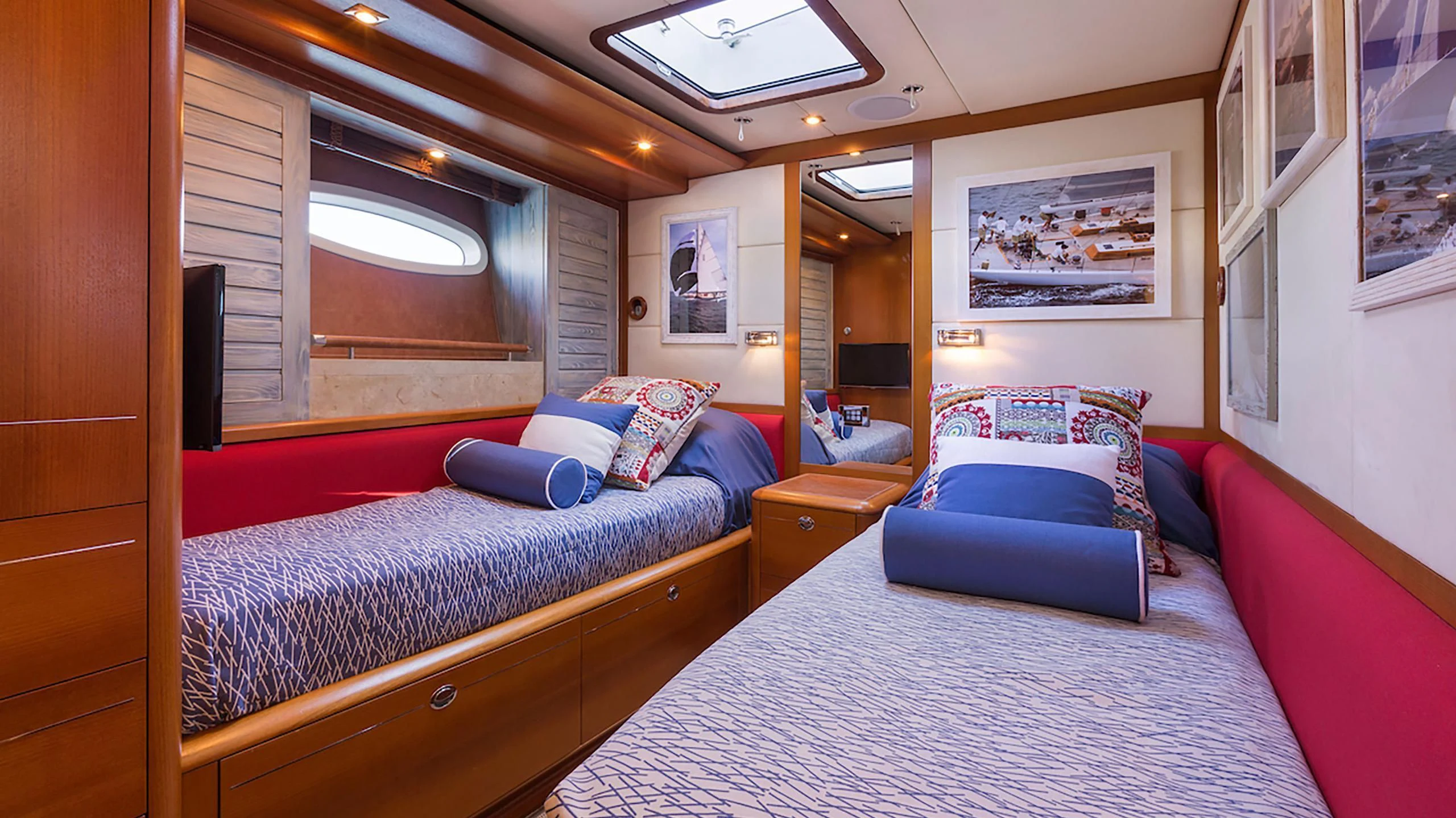 a bedroom with a bed and a window aboard DANNESKJOLD Yacht for Sale