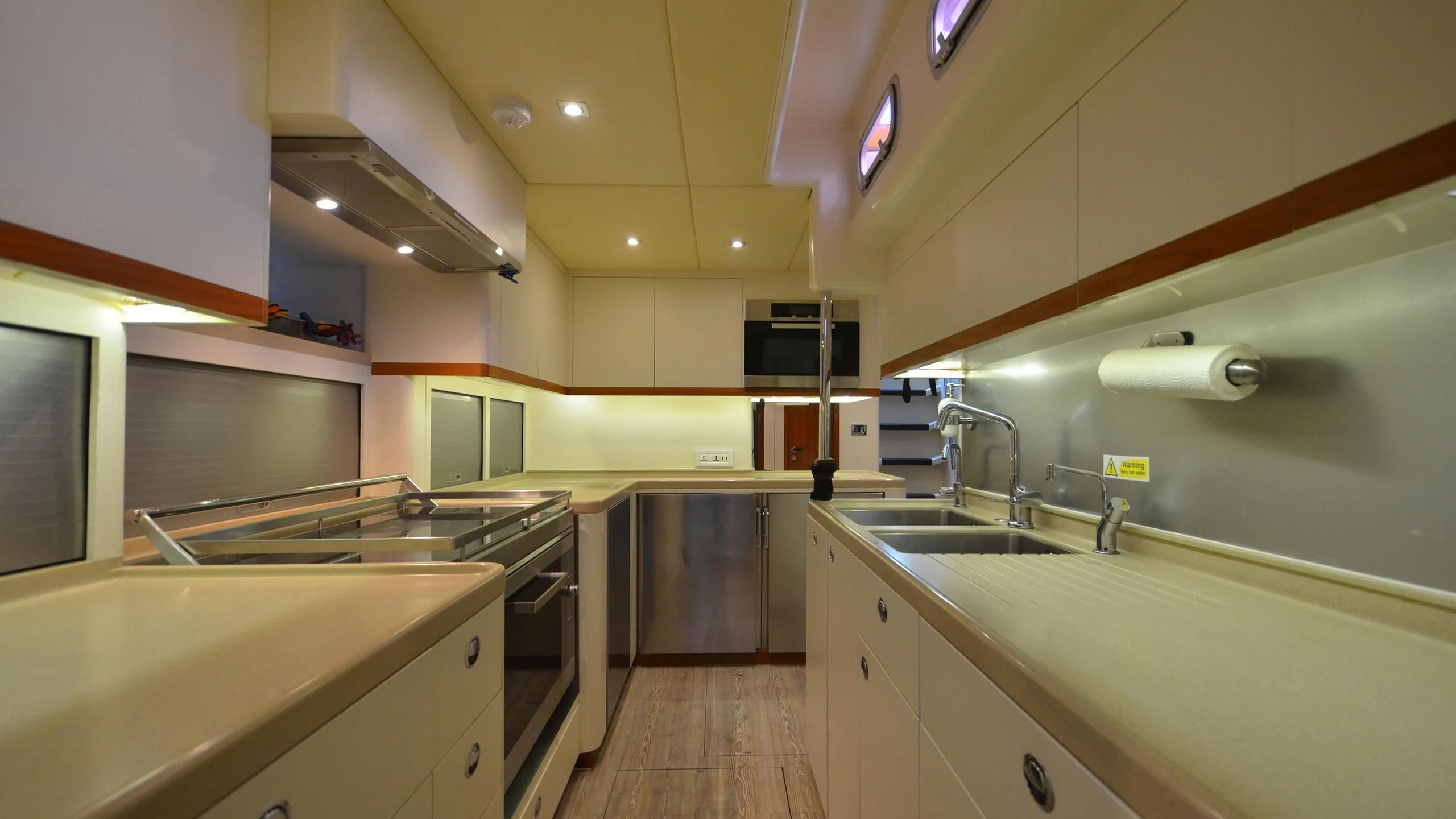 a kitchen with white cabinets aboard DANNESKJOLD Yacht for Sale