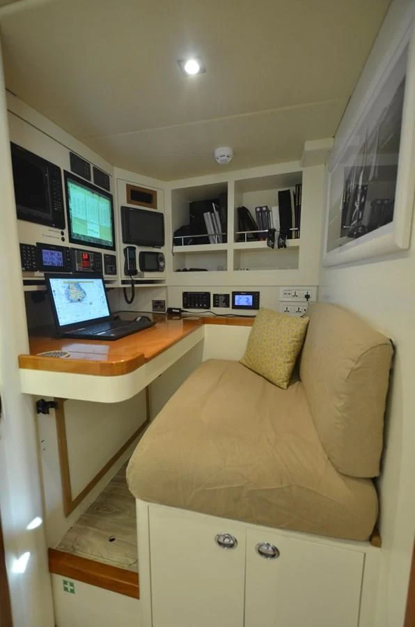 a laptop on a desk aboard DANNESKJOLD Yacht for Sale
