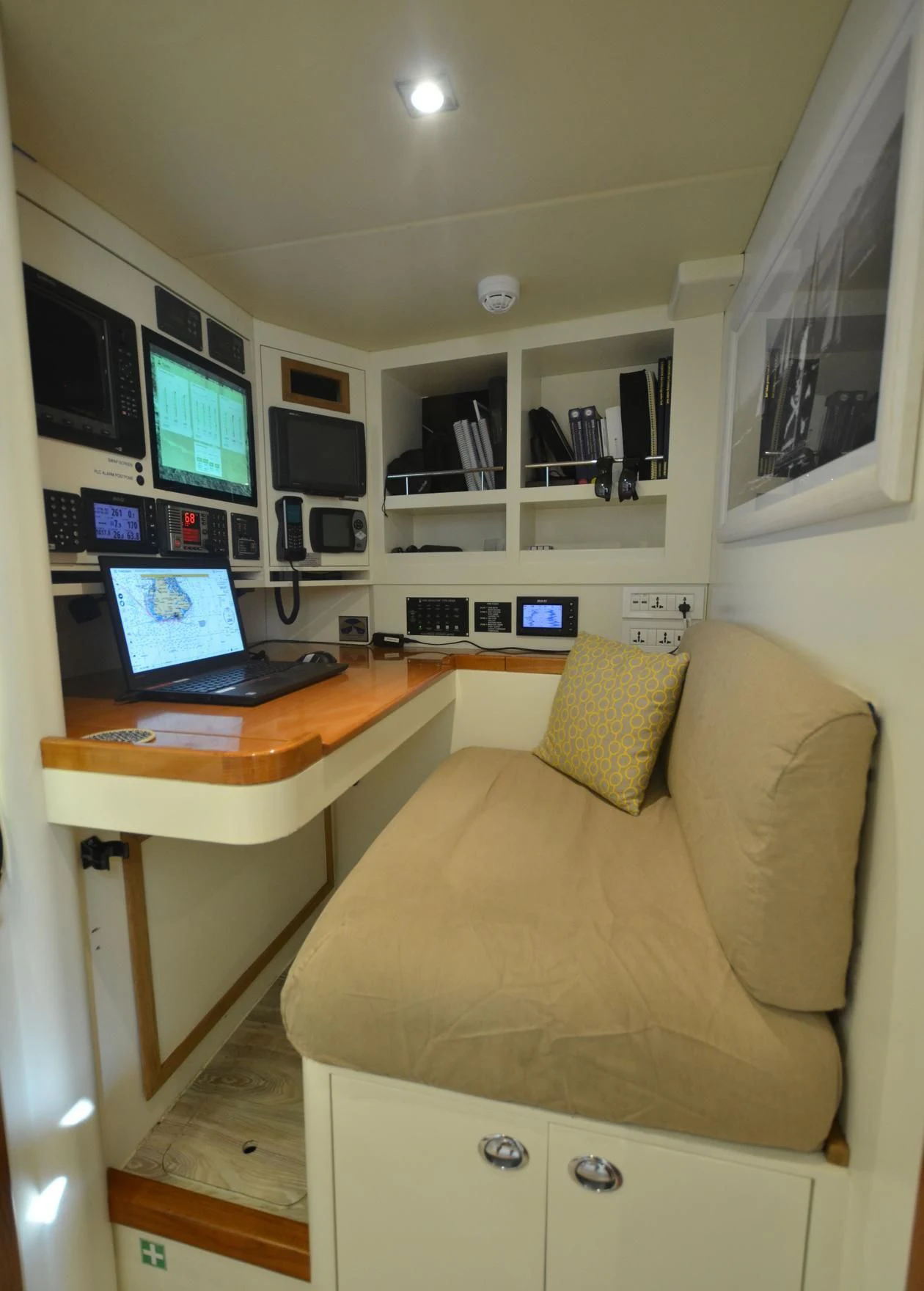 a living room with a laptop on a desk aboard DANNESKJOLD Yacht for Sale