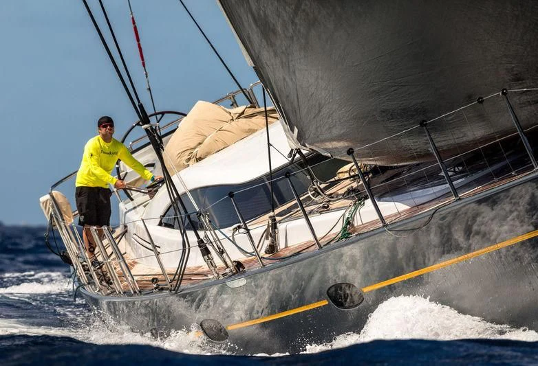 a man standing on a boat aboard DANNESKJOLD Yacht for Sale